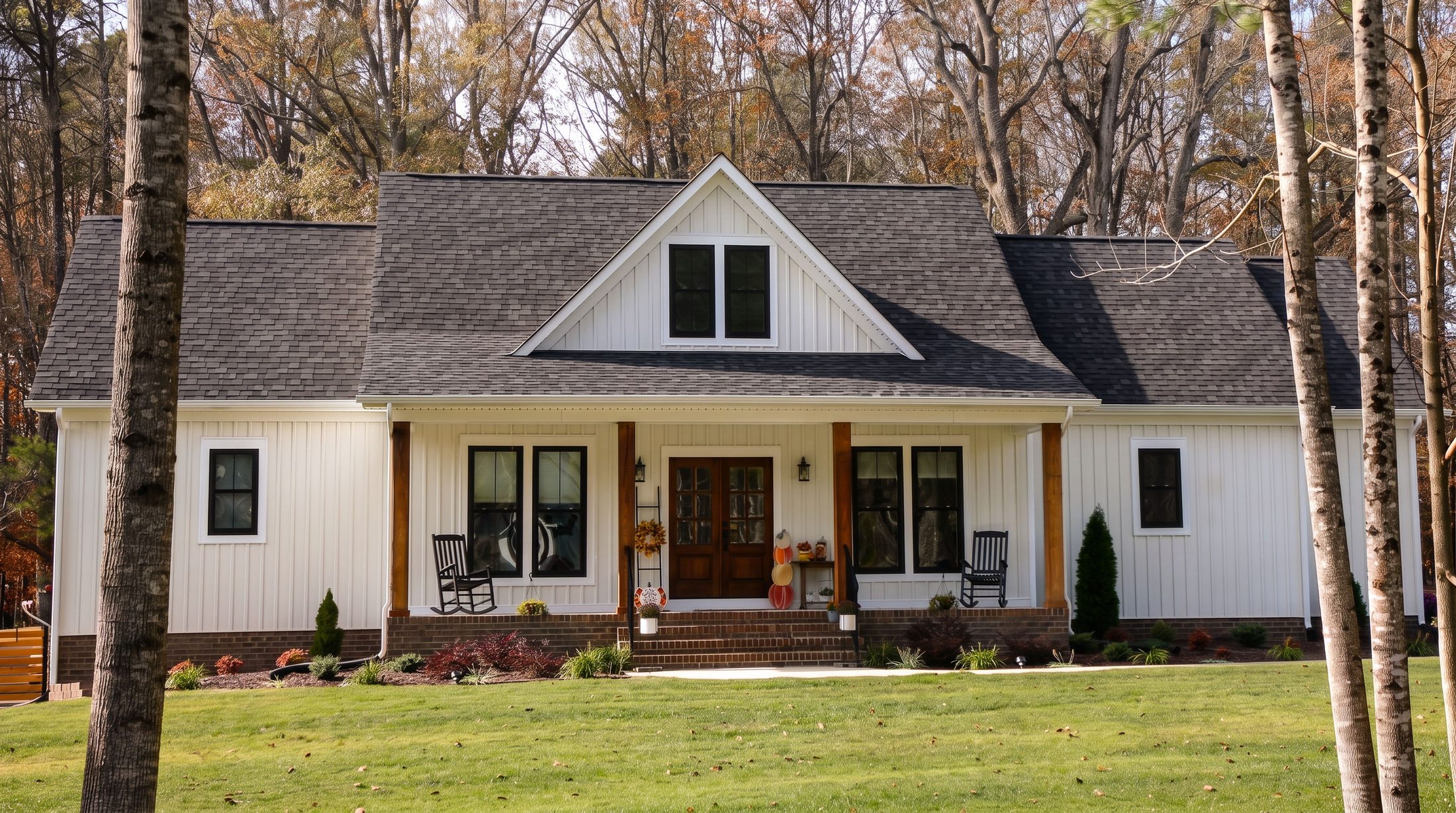 The Olender — a white board-and-batten farmhouse with a covered front porch